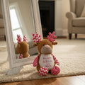 Personalised plush deer Snowy sitting in front of a mirror