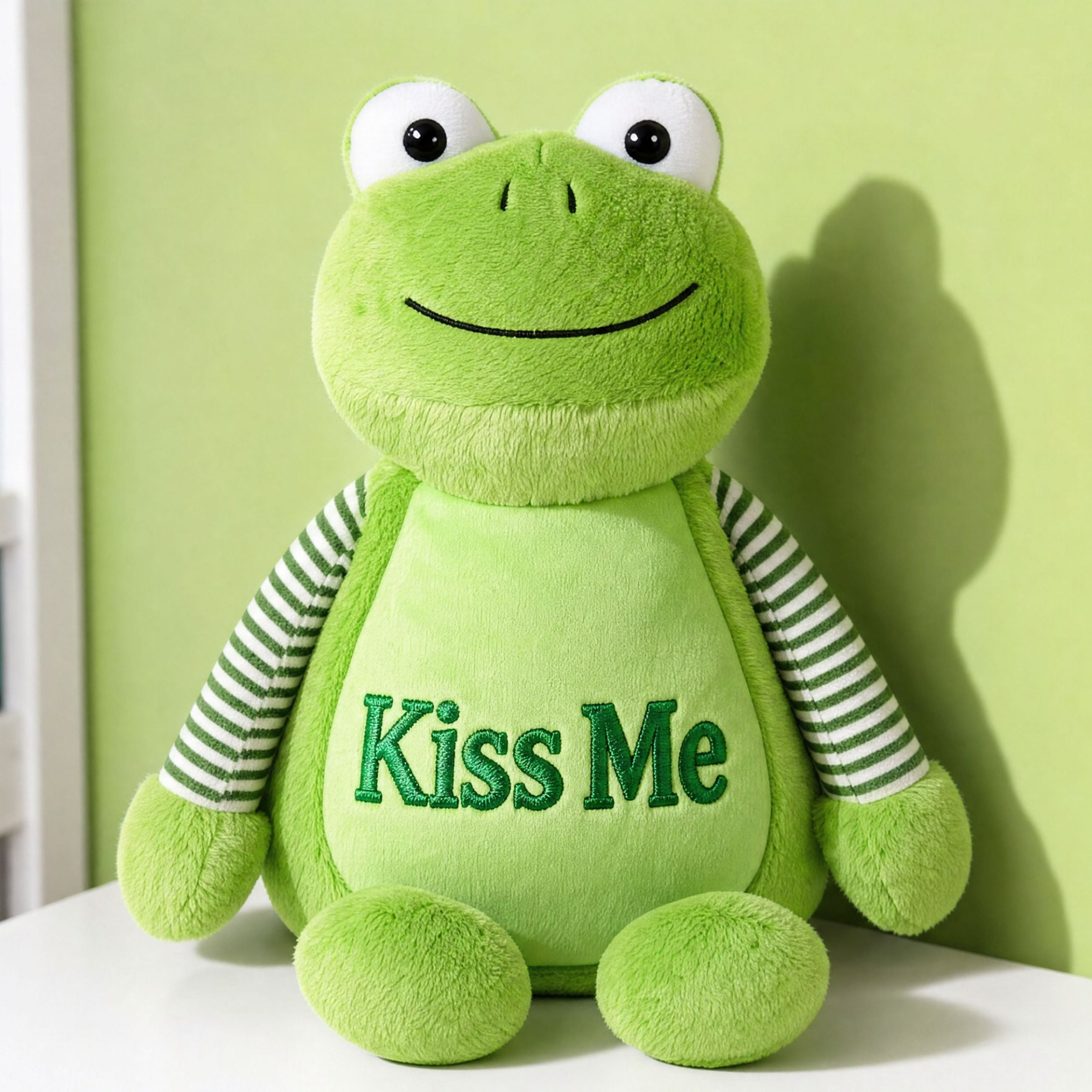 Woman holding Hoppy personalised green frog plush toy with embroidered name