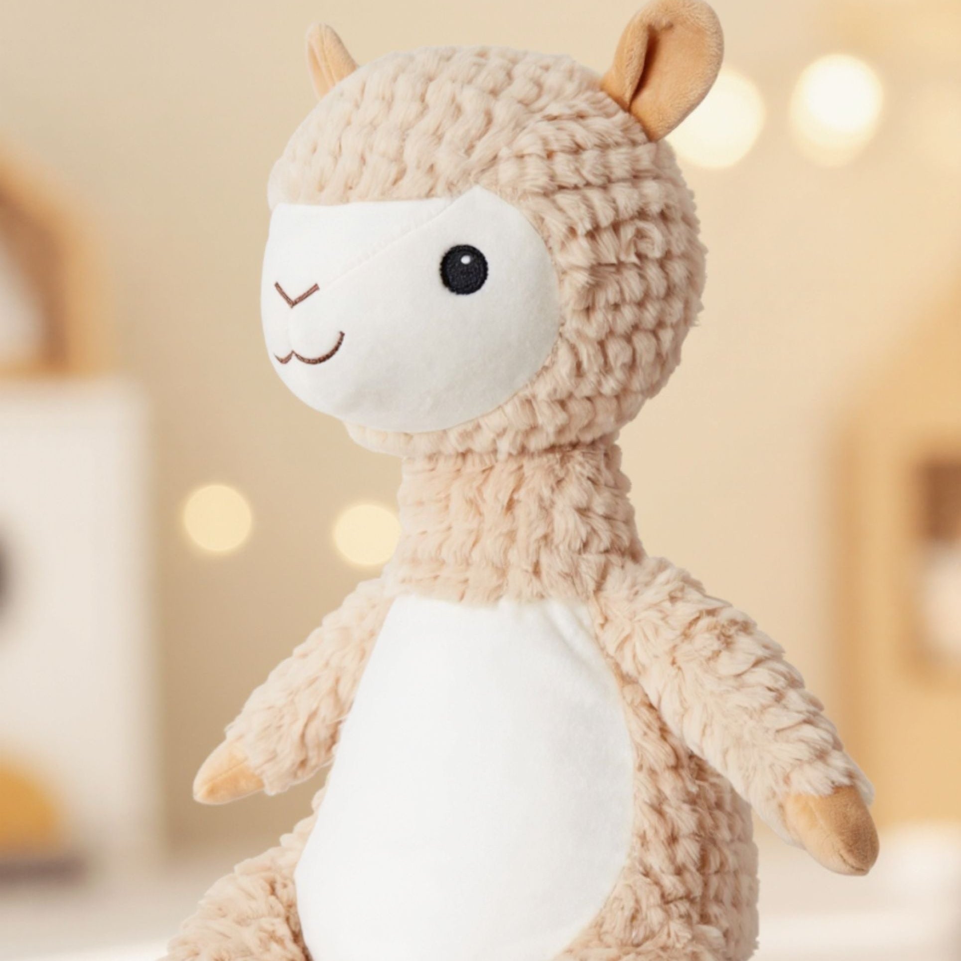 Side view of personalised Allie alpaca plush toy with embroidered name, soft personalised keepsake gift.