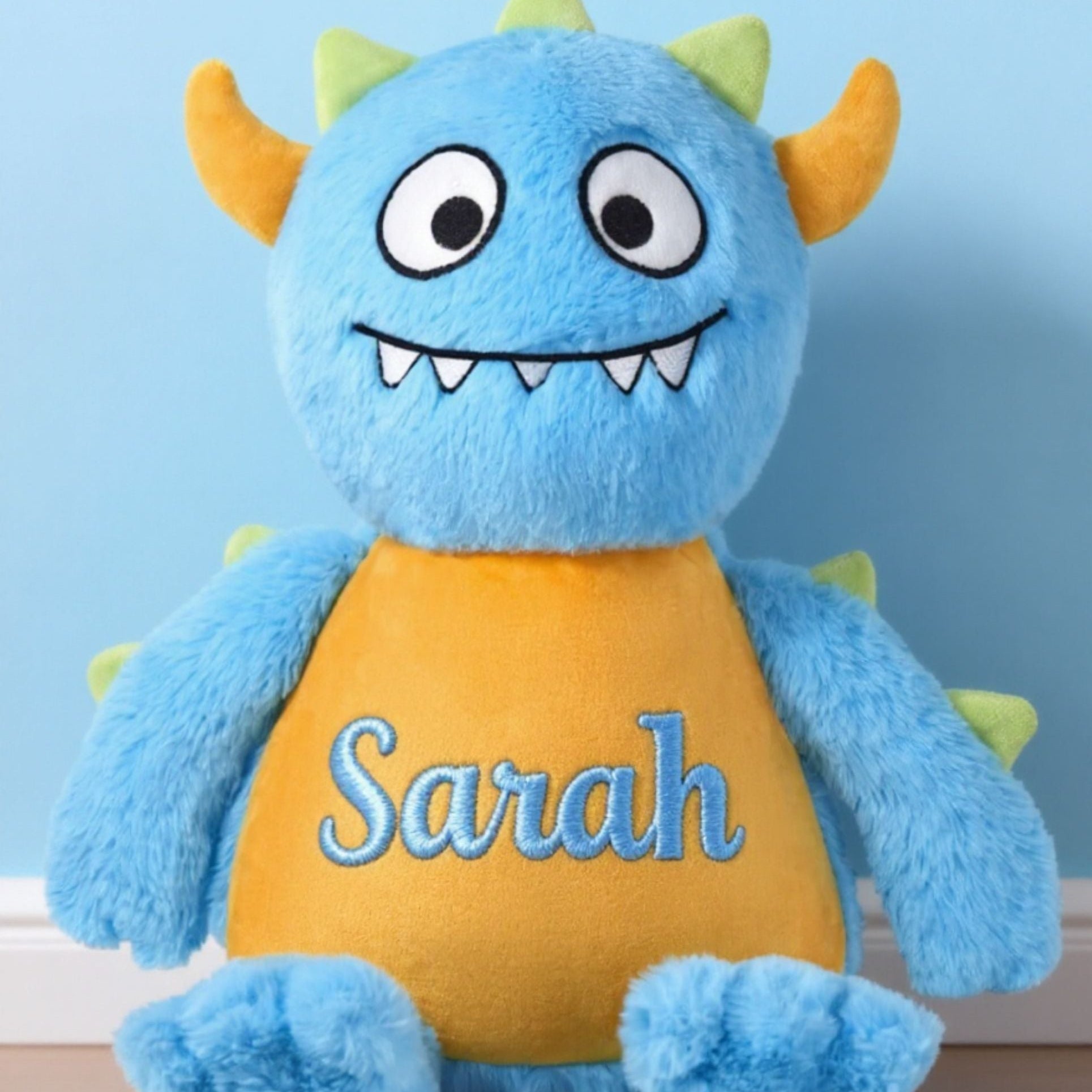 Personalised blue monster plush toy front view with embroidered name detail