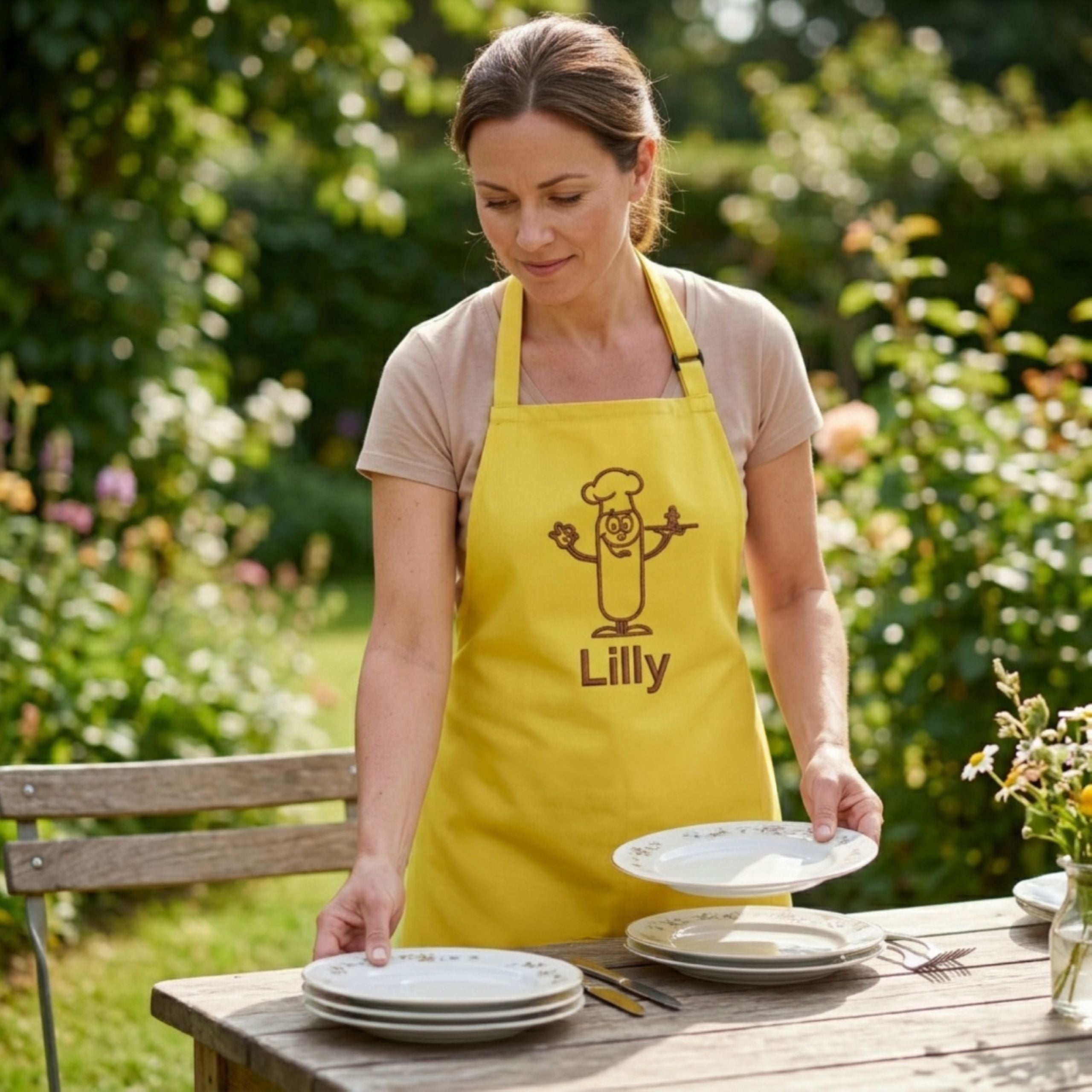 Woman in personalised apron placing plates on table in kitchen setting