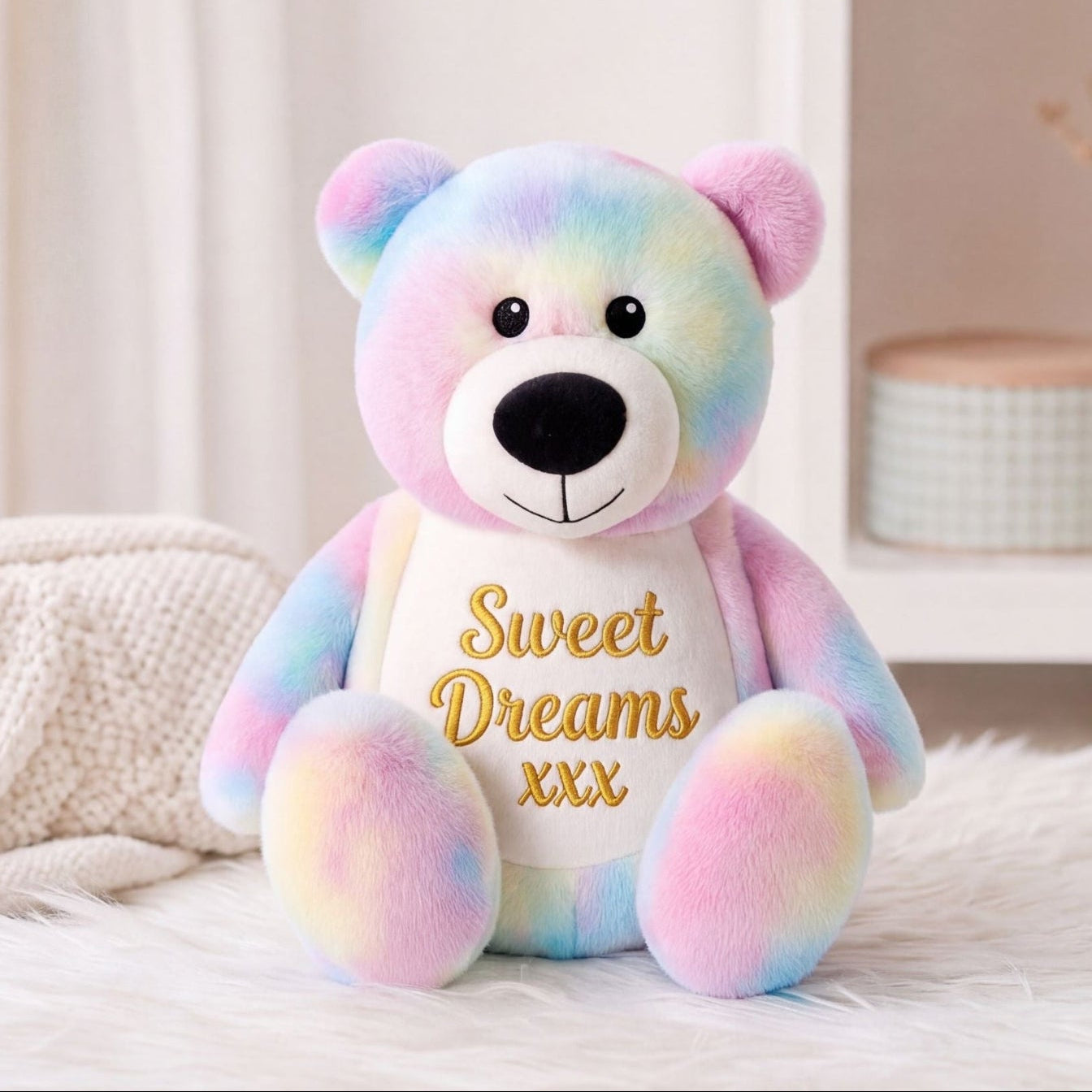 Close-up of colourful personalised tie dye bear with embroidered name. Perfect gifts 