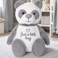 Chester the panda plush sitting alone on the floor in a child's bedroom, personalised teddy bear gift