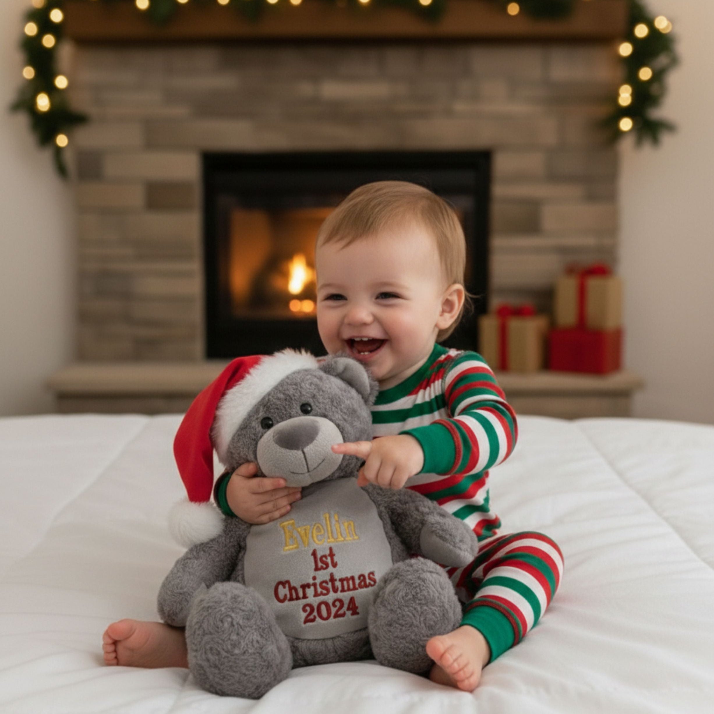 Little girl playing with personalised Christmas bear Holly soft plush toy