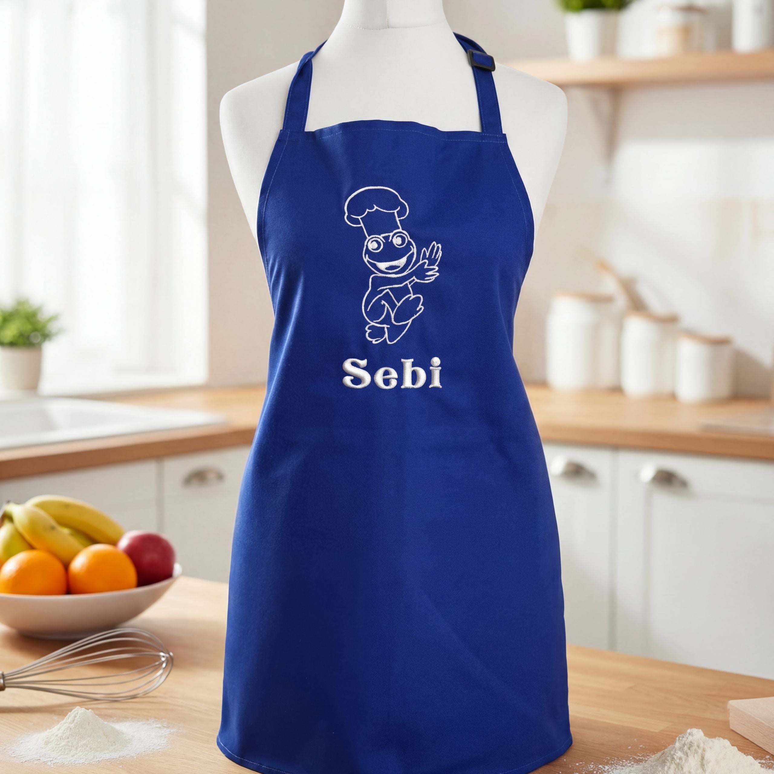 Close-up of personalised blue children’s apron with embroidery