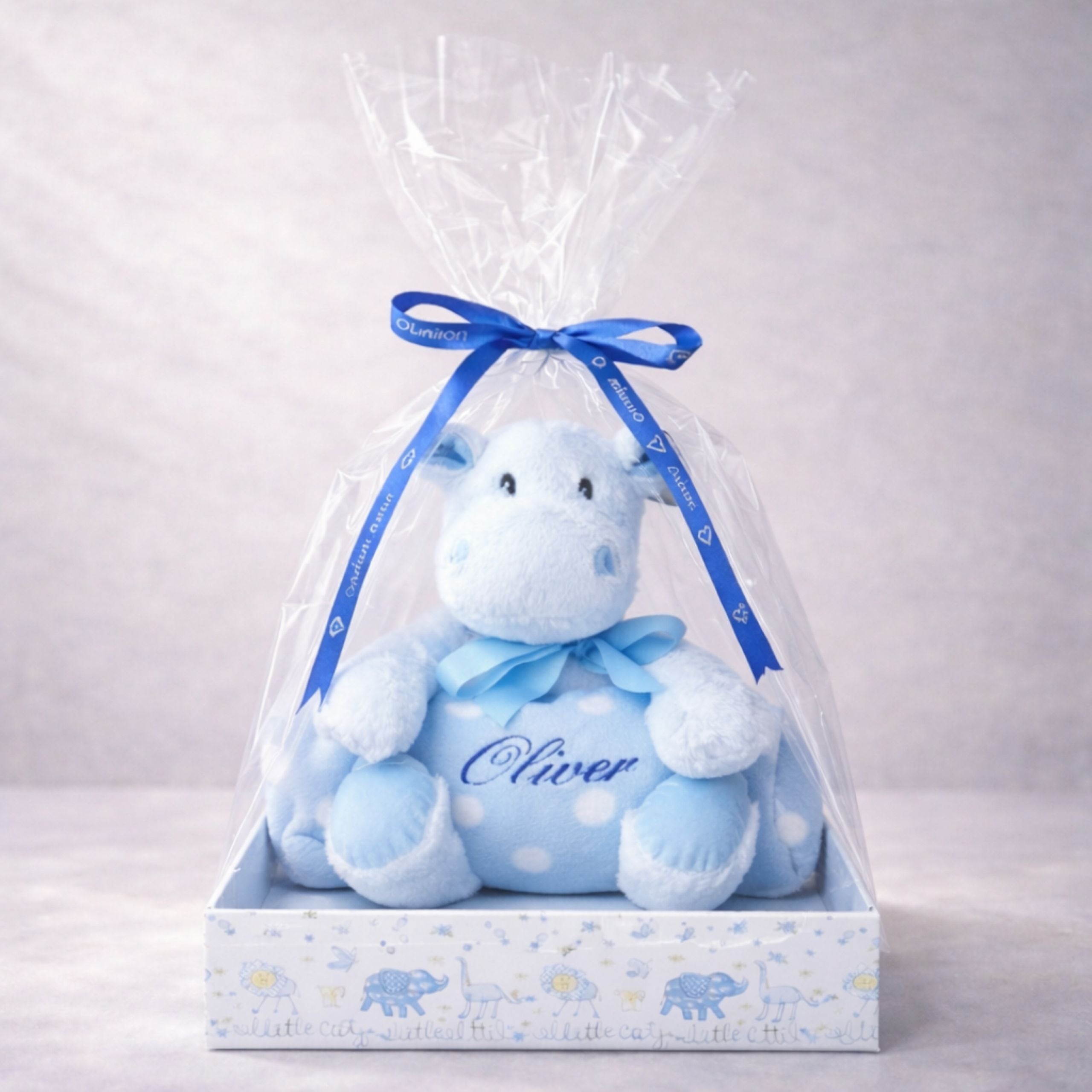 
Personalised blue hippo plush toy with the name Oliver sitting on a nursery shelf