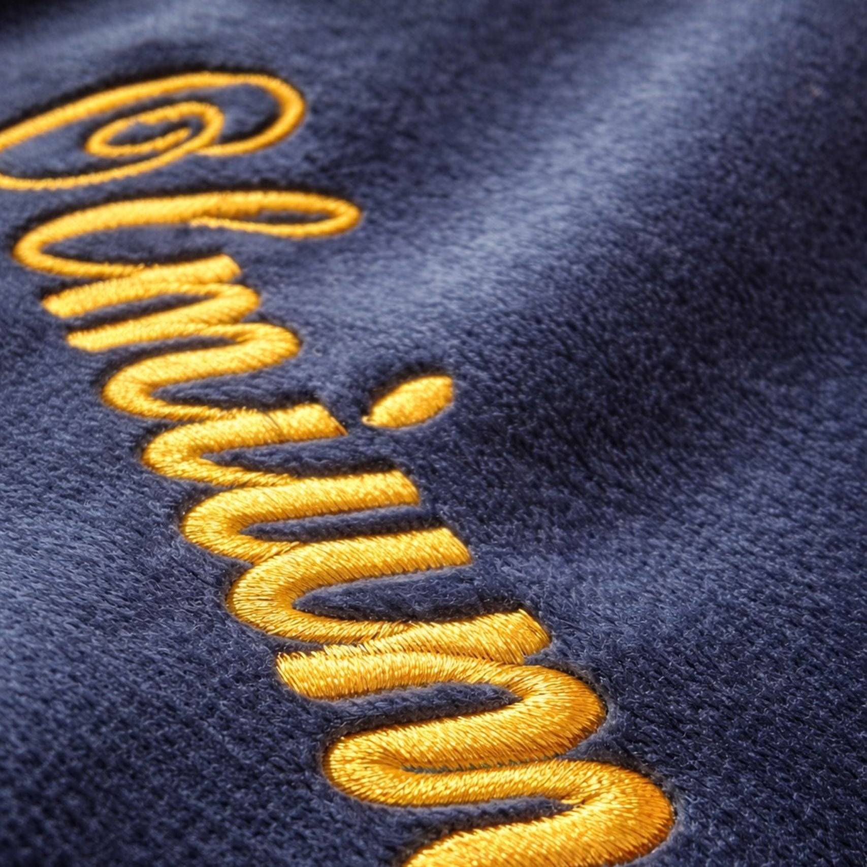 Close-up detail of metallic embroidery stitching on personalised cosmetic bag