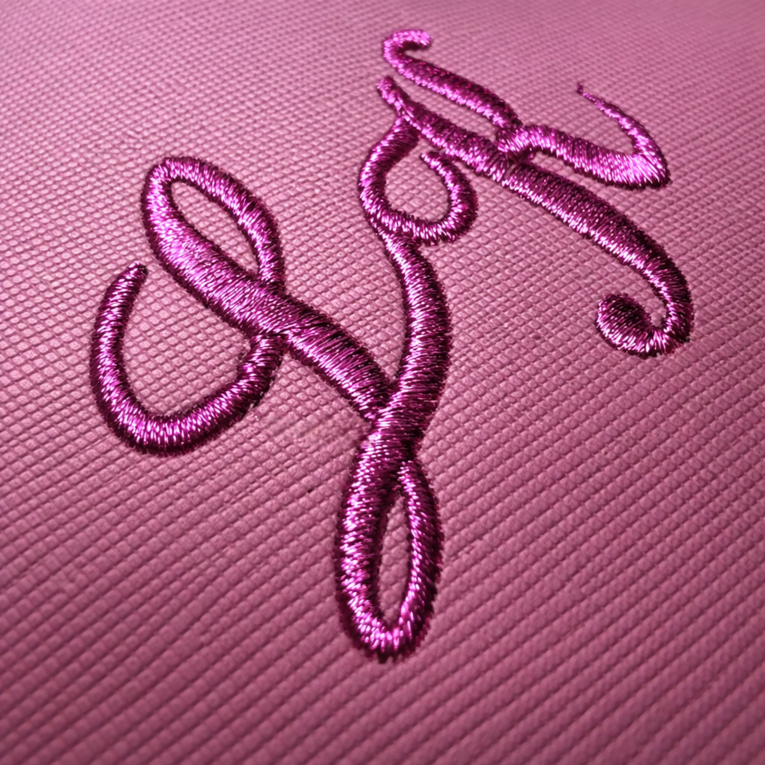 Detailed close-up of personalised bag with shimmering metallic thread embroidery