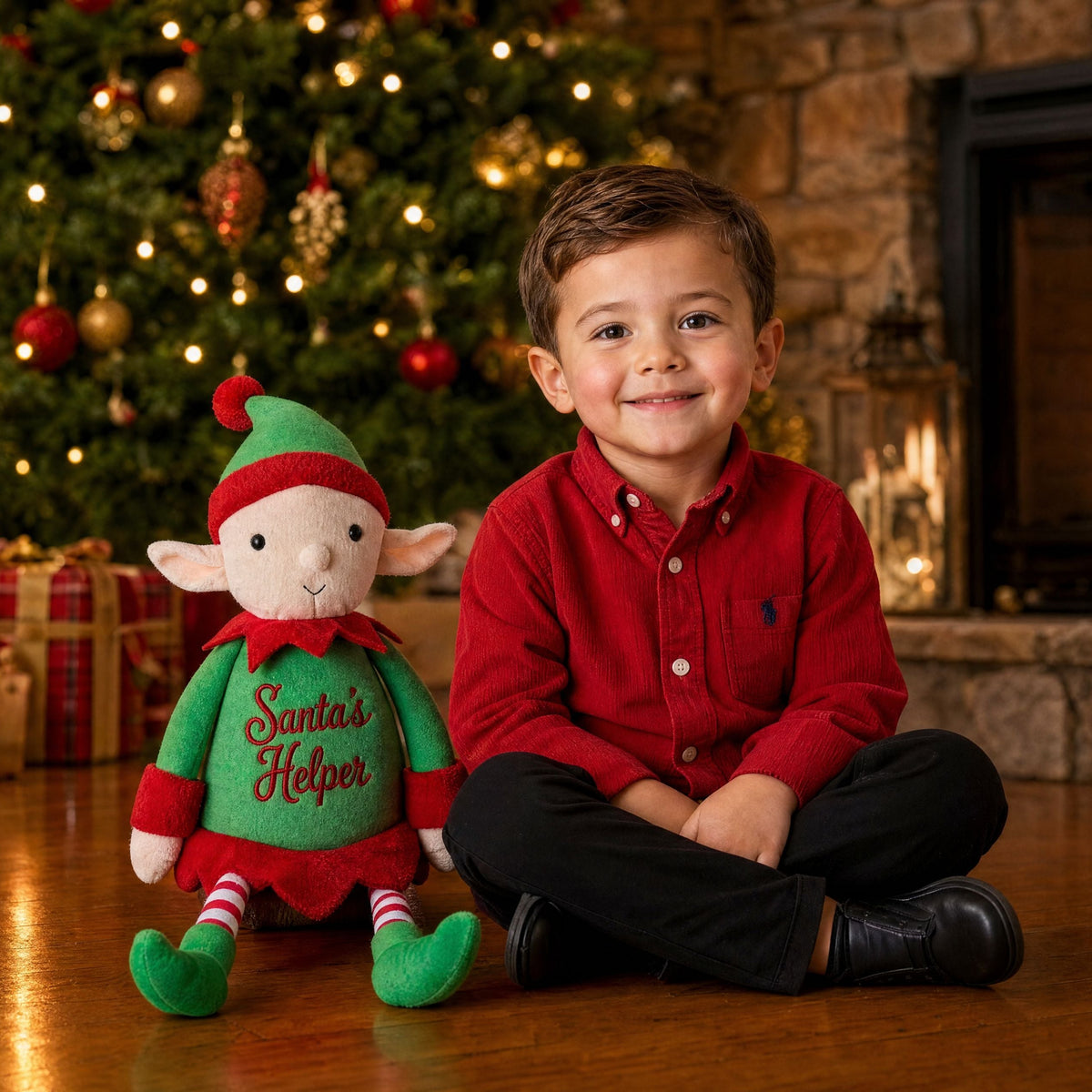 Personalised Christmas elf Jolly sitting beside a boy in front of a Christmas fireplace