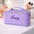 Close-up of personalised cosmetic bag with metallic embroidered name detail
