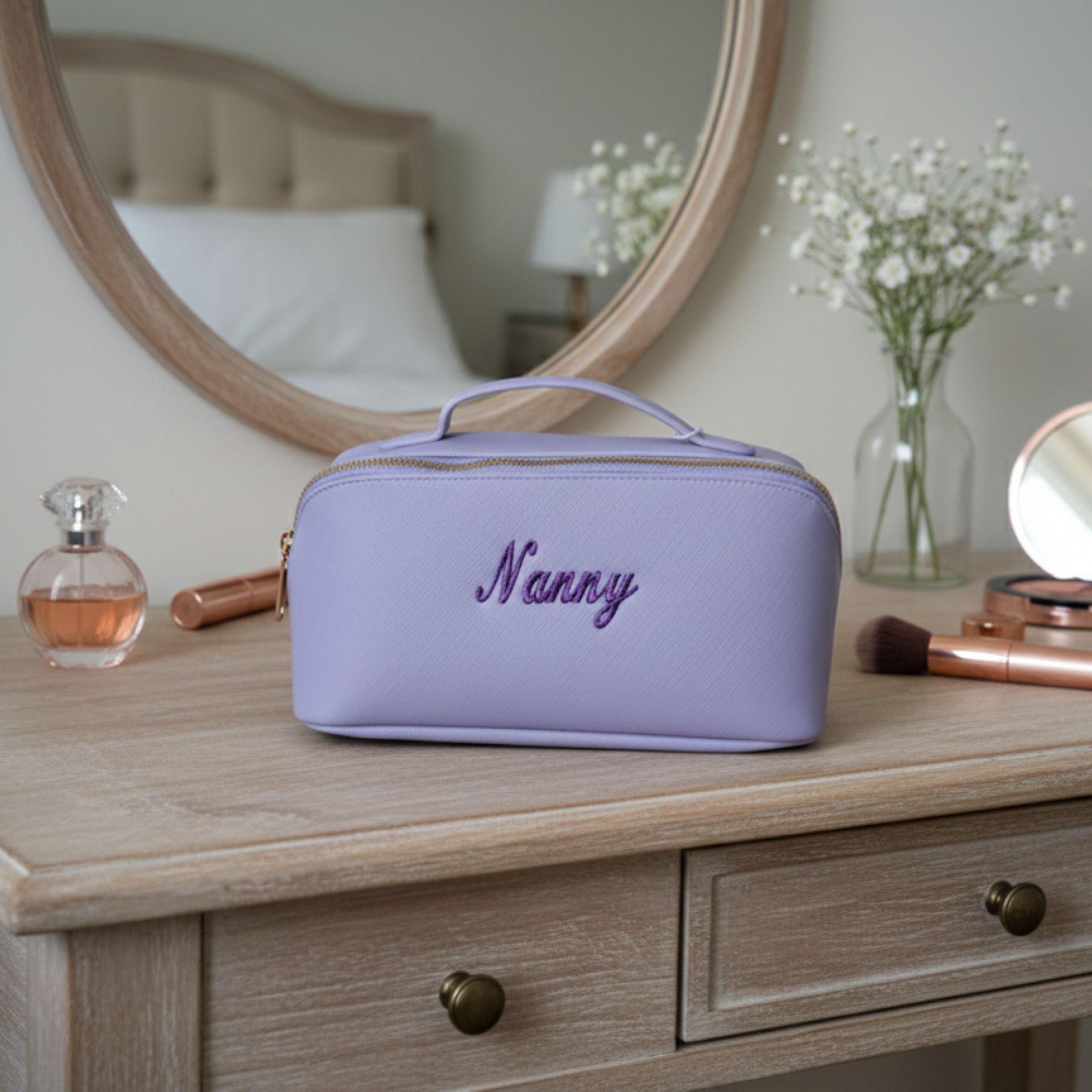 Personalised cosmetic bags in different colours held by woman