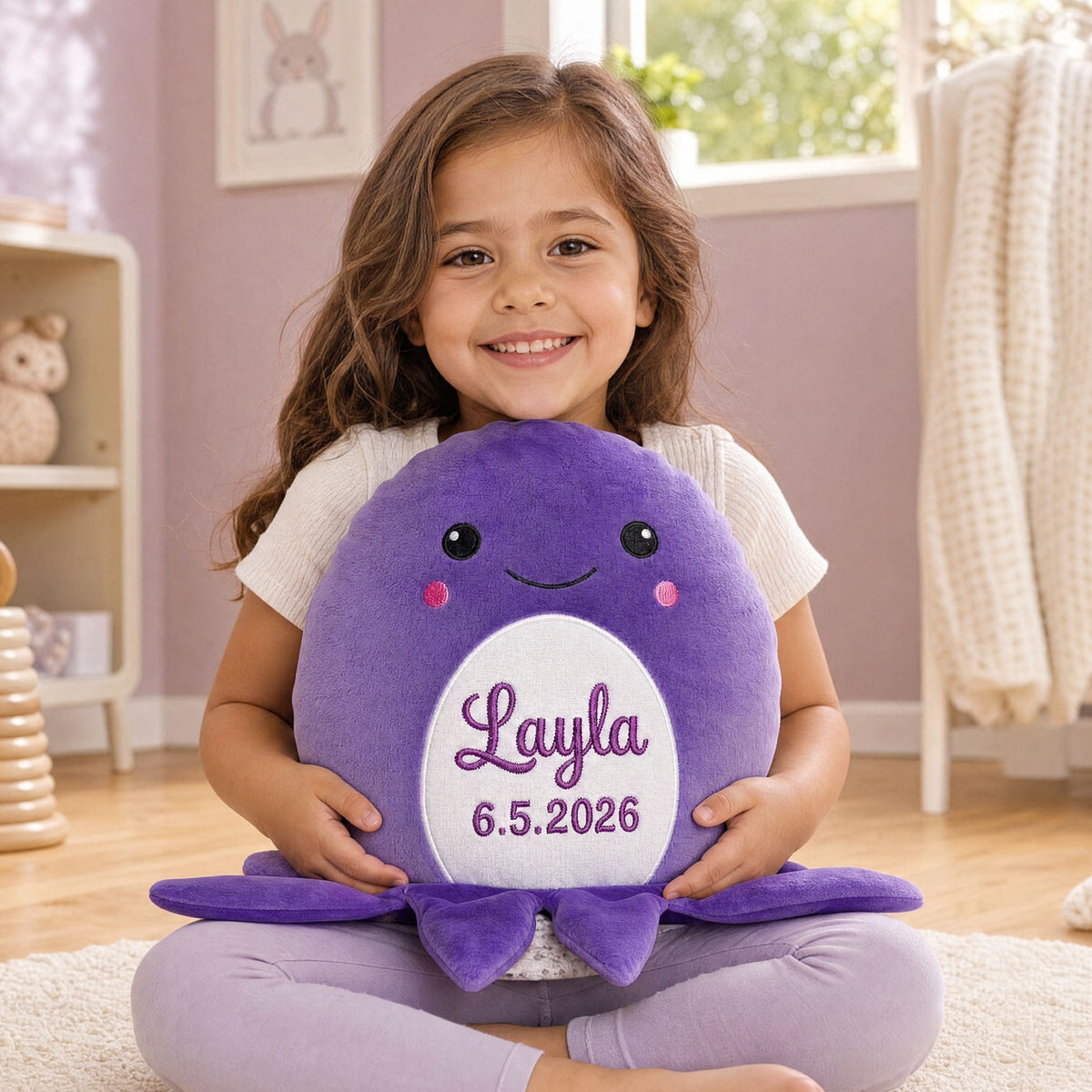 Personalised plush octopus Clover sitting on the floor in a children's bedroom