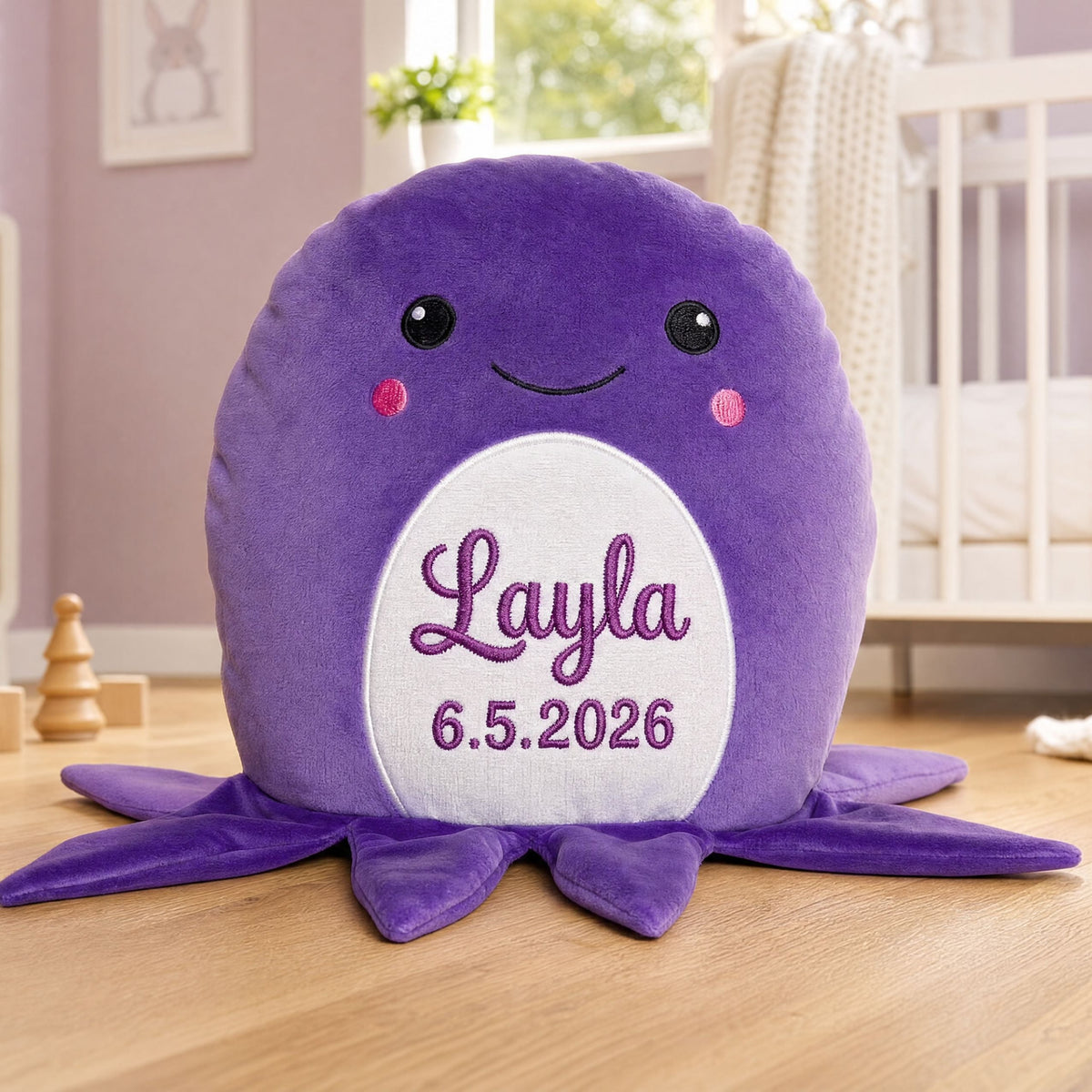 Personalised purple plush octopus Clover sitting beside a girl on the floor