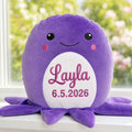 Personalised plush octopus Clover with embroidered name sitting on a windowsill