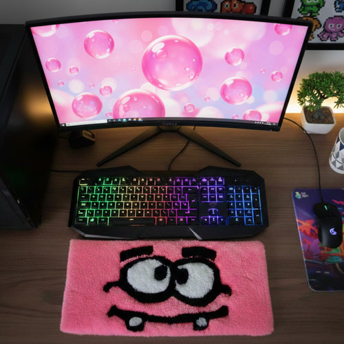 Pink Eyes Character handmade tufted keyboard rug placed under computer keyboard