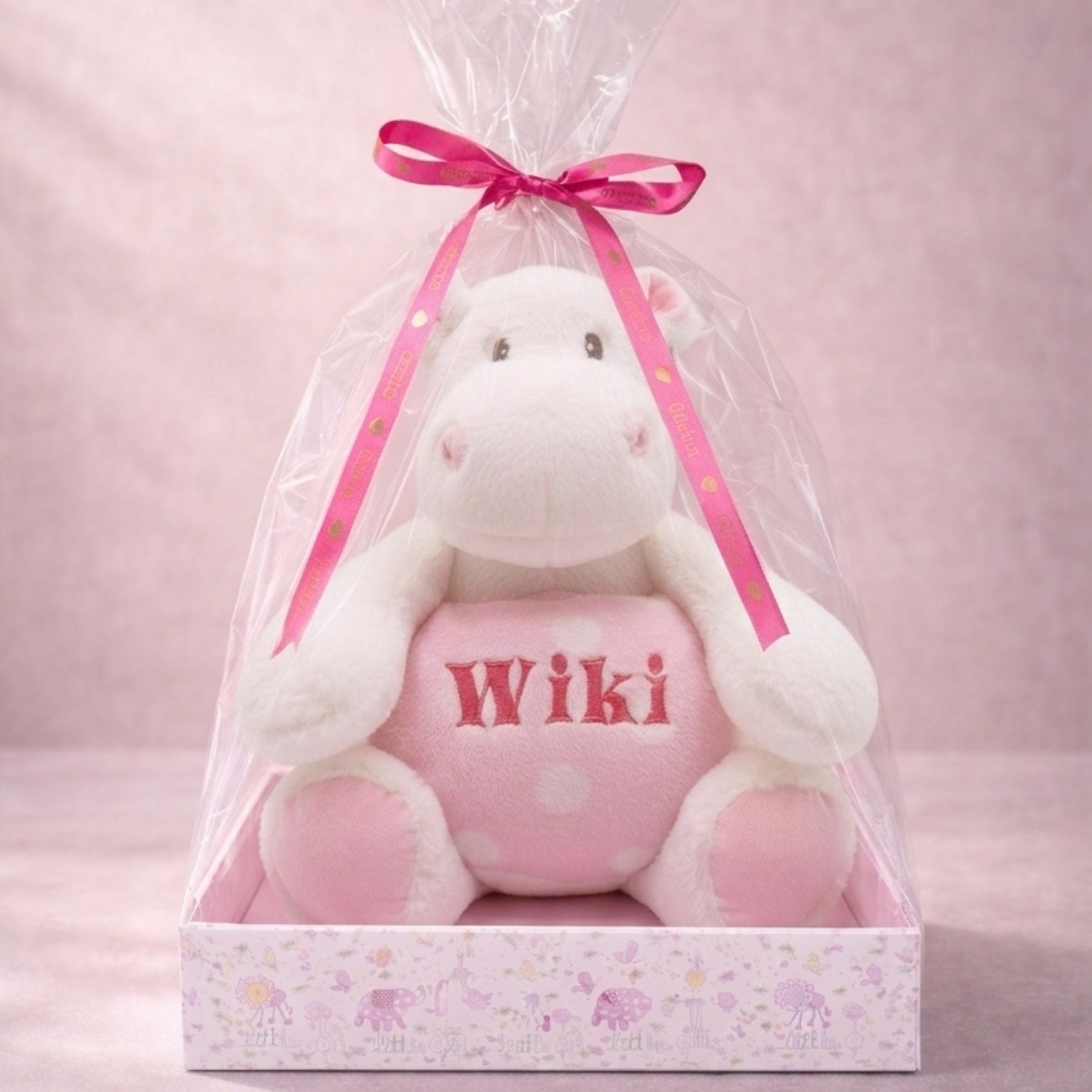 Pink plush hippo toy with Wiki embroidery in a pink gift package with ribbon