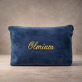 Close-up of personalised velvet accessory bag with metallic embroidered name and gold zip