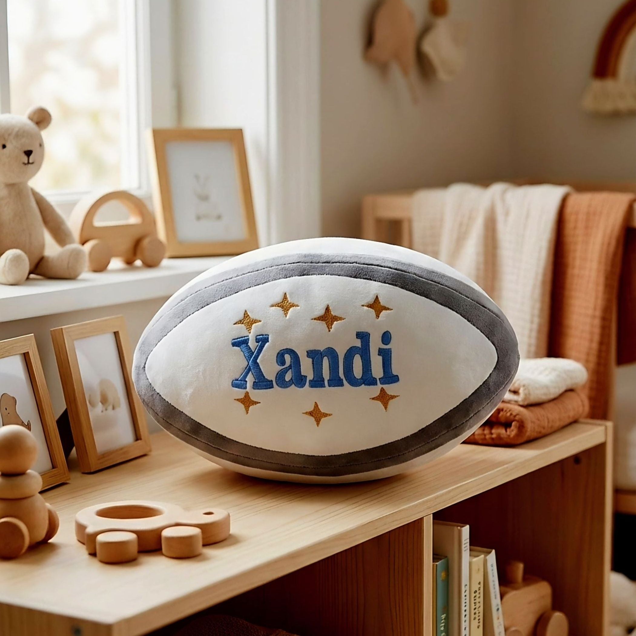 Collection of personalised Zippy plush rugby balls with different names and decorative stars